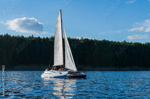 catamaran sailing boat on the background of the shore
