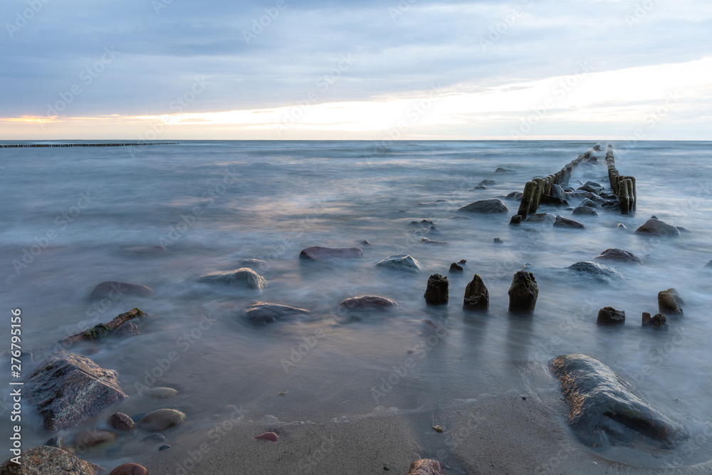 baltic sea with old breakwaters and stones on the coast on a long exposure baltic sea with old breakwaters and stones on the coast on a long exposure
