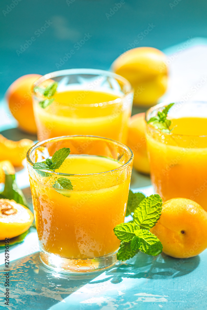 Glass of fresh healthy apricot juice in sunny light Glass of fresh healthy apricot juice in sunny light