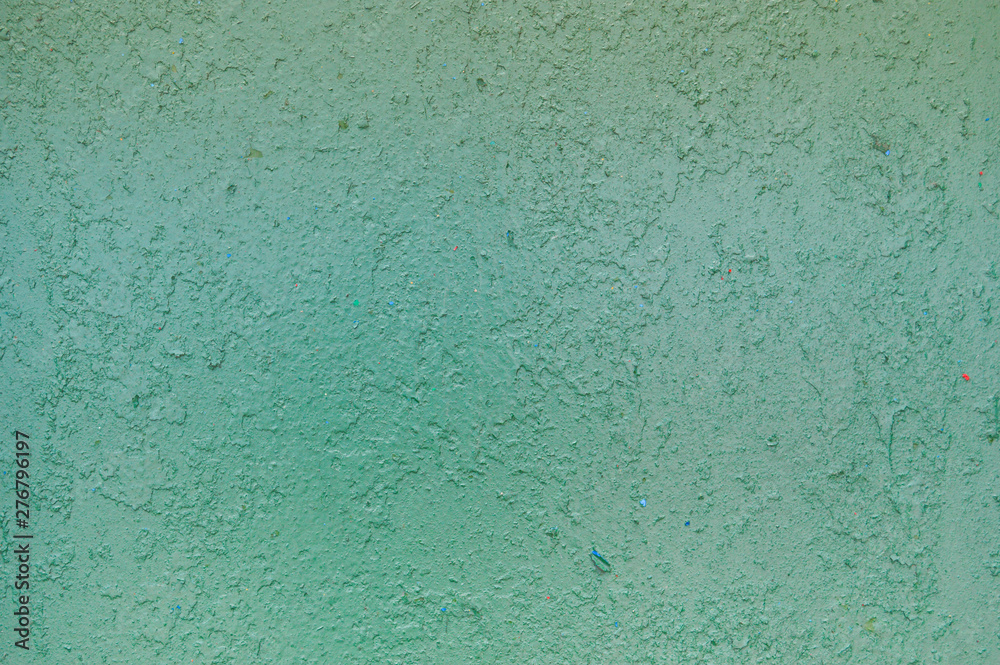 Texture of iron metal painted bright green peeling paint of old battered scratched cracked ancient rusty metal sheet wall with corrosion. The background Texture of iron metal painted bright green peeling paint of old battered scratched cracked ancient rusty metal sheet wall with corrosion. The background