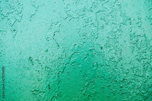 Texture of iron metal painted bright green peeling paint of old battered scratched cracked ancient rusty metal sheet wall with corrosion. The background