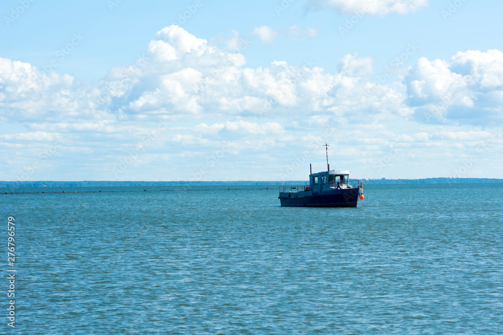 Old wooden fishing boat trawler on sea. Old wooden fishing boat trawler on sea.
