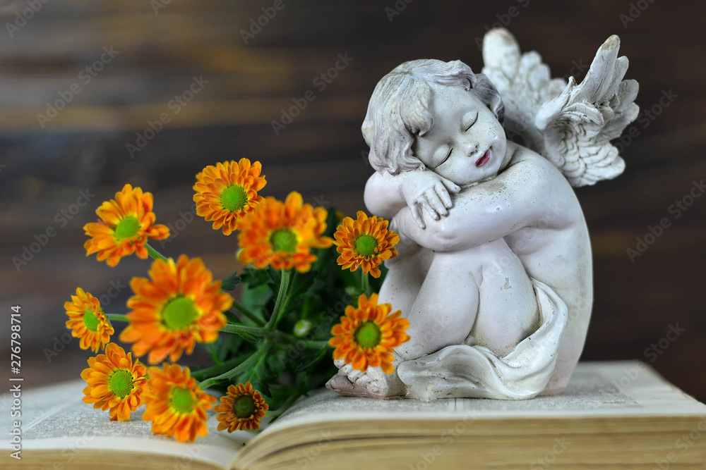 Sympathy card with flowers and angel sleeping on open book Sympathy card with flowers and angel sleeping on open book