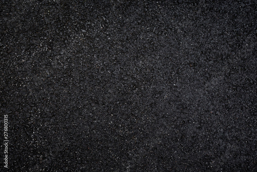 High resolution full frame textured dark background of wet, black asphalt, viewed from above.