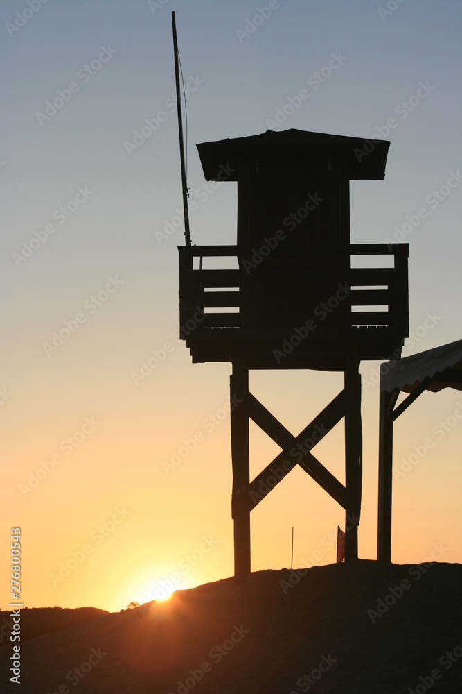 Sunset at the beach in the afternoon with vigilance tower