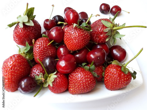 fresh strawberries  and cherries in a bowl