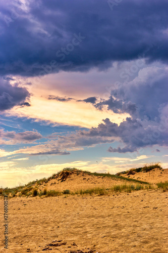 Sunlight in stormy cloudy sky on the beach