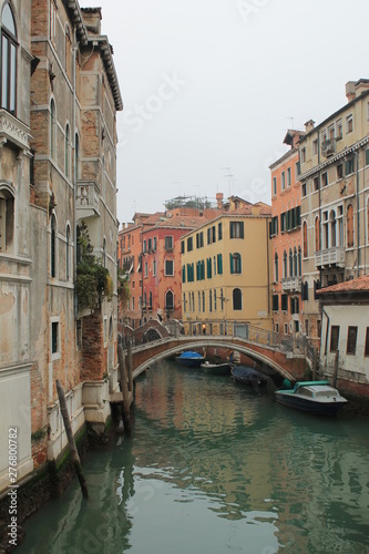 Canal in Venice with arching bridge and reflection