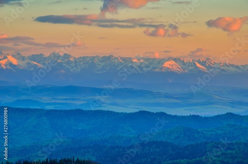 Beautiful mountain landscape. Snow-capped peaks in the light of the setting sun.