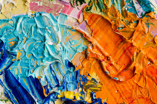 Artist palette with mixed oil paints, macro, colorful stroke texture on canvas, studio shot, abstract art background