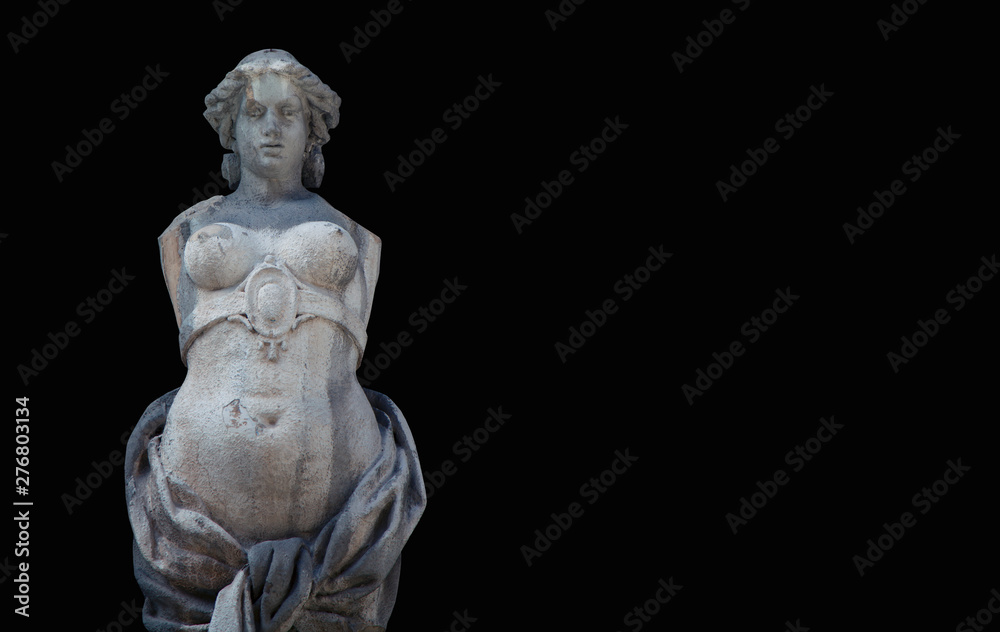 The goddess of love in Greek mythology, Aphrodite (Venus in Roman mythology) Fragment of ancient statue against black background.