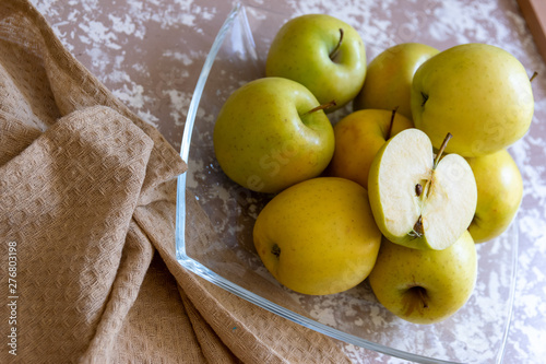 apples on a plate on the table in the kitchen. Chantecler apples. photo