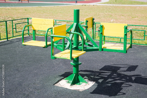Carousel children's metal green on the Playground with rubberized coating. Children sport Hobbies.