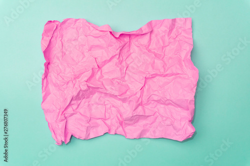 Crumpled paper minimal concept. Сolored paper on a colored background.