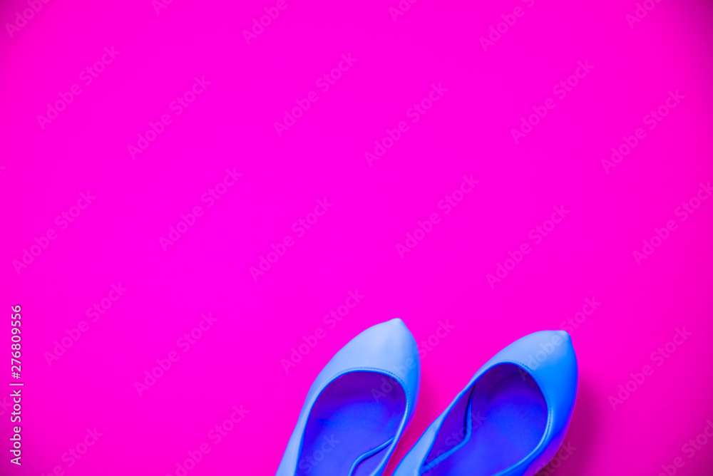 Blue high heeled shoes pink purple background - top view - heels pointing right