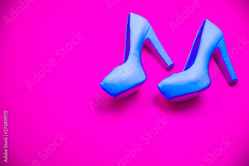 Blue high heeled shoes, pink purple background, top view concept, heels walking