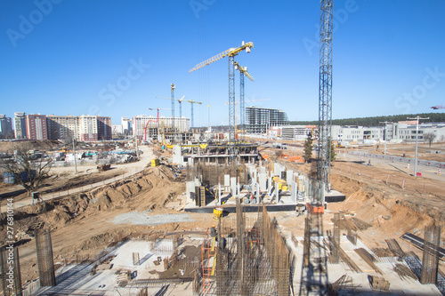  Construction area with yellow cranes at summer time. 