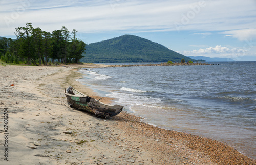 Old broken boat on the shore of Lake Baikal