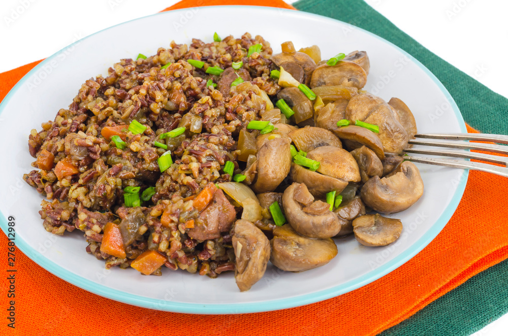 Vegetarian menu, red rice with champignons. Vegetarian menu, red rice with champignons.