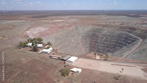 The gigantic mine Kalgoorlie extends to the horizon. Aerial view of the canyon-like mine with its huge trucks in the south west of australia photo