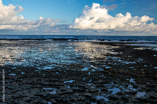 sky reflecting at low tide, revealing the rocks