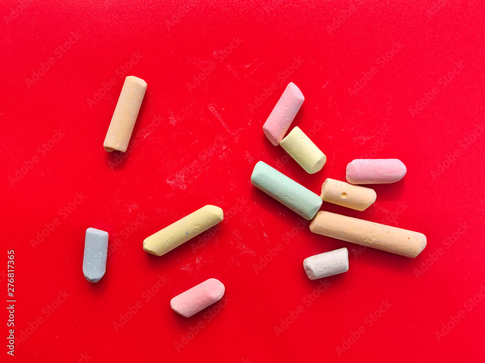 custom made wallpaper toronto digitalBroken multicolored chalk pieces isolated on red background.