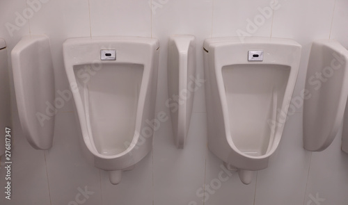 The white urinals on white wall 