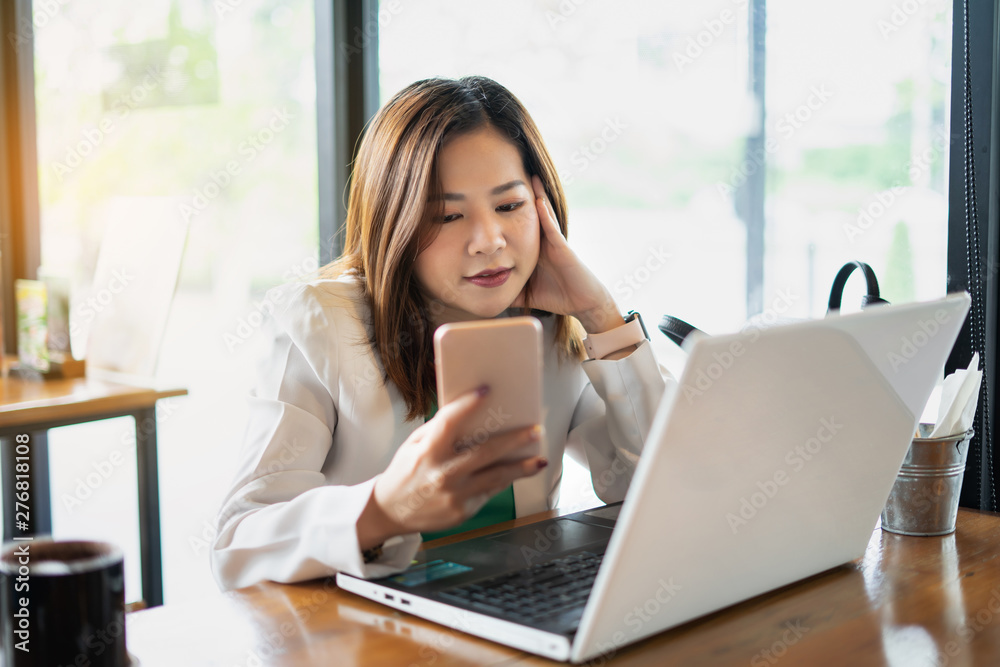 business woman working with use computer and smartphone in coffee shop. business relaxing and break time. freelance working and freedom work. business finance success. business woman working with use computer and smartphone in coffee shop. business relaxing and break time. freelance working and freedom work. business finance success.