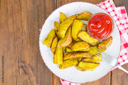Baked potato wedges with country style herbs on plate