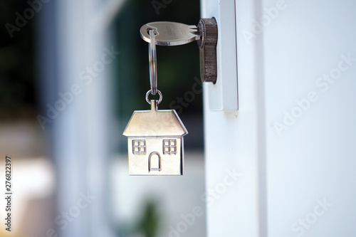 Home key for unlocking the new house door. Renting, buying, selling houses © Shisu_ka