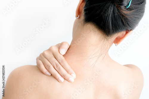 Women have neck pain, shoulder pain, at the park health concept.