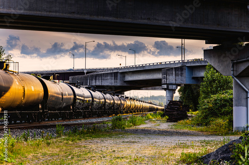 Beautiful light reflection off train cars traveling under bridge