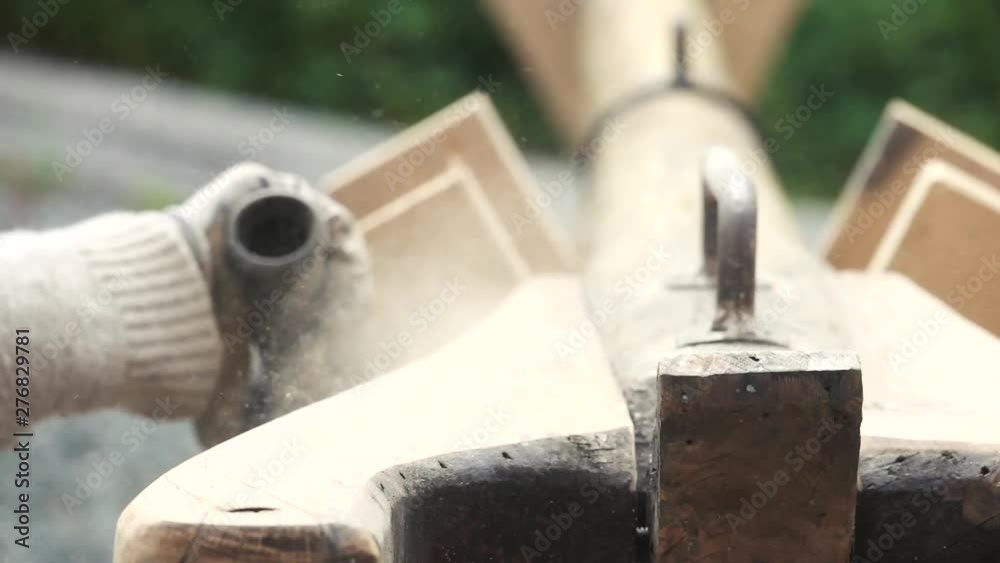 Close up on disk grinder getting off old layer of lacquer on sail boat mast. Slow motion. Close up on disk grinder getting off old layer of lacquer on sail boat mast. Slow motion.