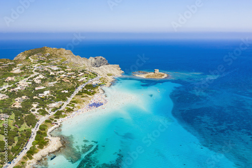 Stunning aerial view of the Spiaggia Della Pelosa (Pelosa Beach) full of colored beach umbrellas and people sunbathing and swimming in a beautiful turquoise clear water. Stintino, Sardinia, Italy.