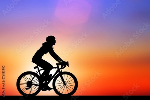 Fototapeta Naklejka Na Ścianę i Meble -  Silhouette  Cycling  on blurry sunrise  sky   background.