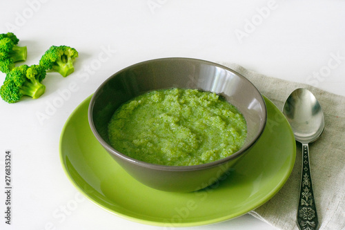 Vegetarian soup of broccoli puree on a white background. The concept of healthy eating.