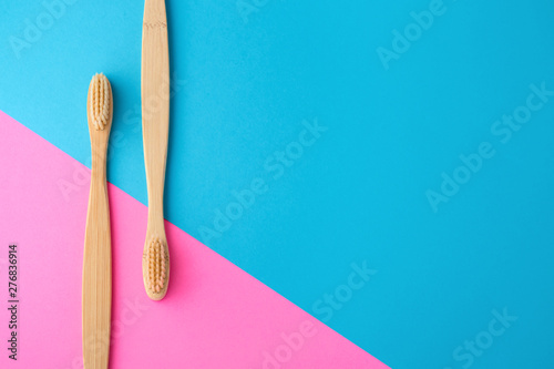 Bamboo toothbrushes on pink and blue background