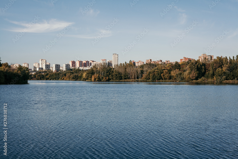 Autumn city landscape with  wide river