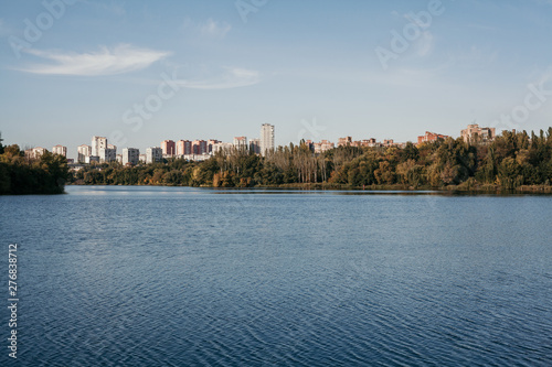 Autumn city landscape with wide river