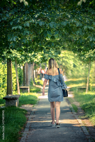 Longhair blond beauty walks through the park on the way to work © diwali