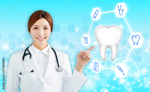 Smiling female doctor pointing health tooth icon