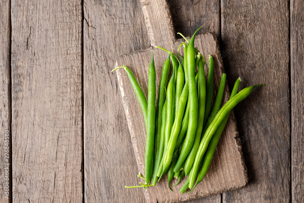 Overhead shot of fresh green bean on wooden table Overhead shot of fresh green bean on wooden table