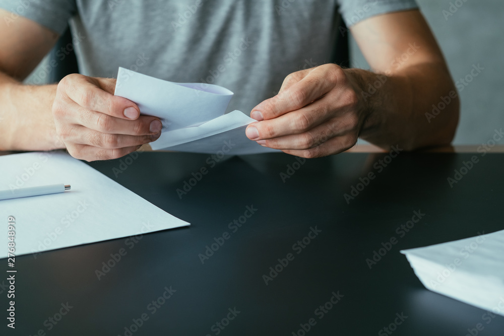 Written communication. Cropped shot of man inserting letter into envelope. Copy space. Written communication. Cropped shot of man inserting letter into envelope. Copy space.