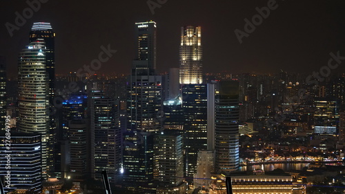 Landscape views of Singapore skyline at night. Buildings with offices and tall skyscraper as foreground.