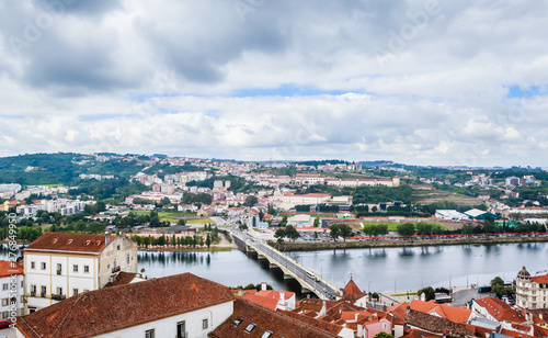 Cityscape over the roofs of Coimbra with the Mondego River, Portugal photo