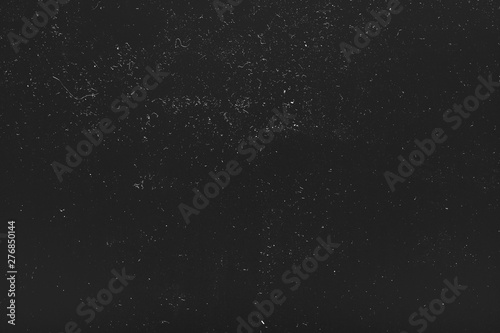 Fototapeta Naklejka Na Ścianę i Meble -  White dust and scratches over black surface. Aged metal pattern background. Empty space.