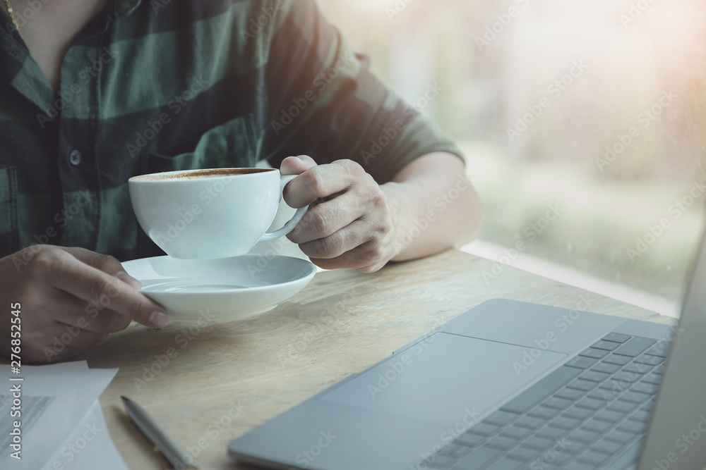 Businessman, accountant, economist Resting, drinking coffee during work with laptop computer and calculator. relax concept. Businessman, accountant, economist Resting, drinking coffee during work with laptop computer and calculator. relax concept.