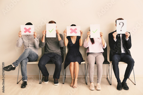 Young people holding paper ...