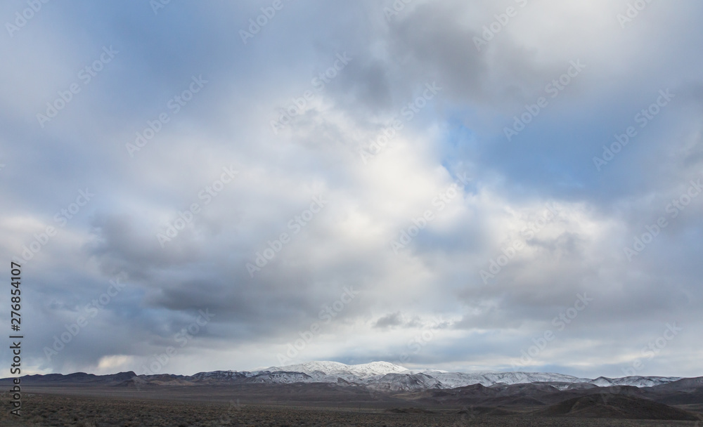 Overcast sky above snow capped mountain