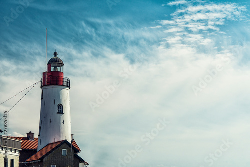 lighthouse along the IJsselmeer in Urk, The Netherlands. Cloudy, Space for text